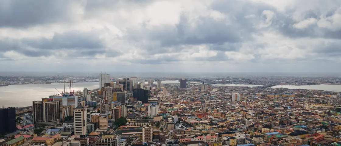 Lagos from the air — dense city blocks running down to the waterfront.